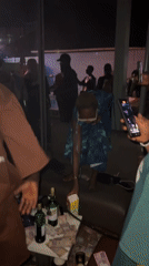 Nighttime party with dancing and poolside activities in Awka