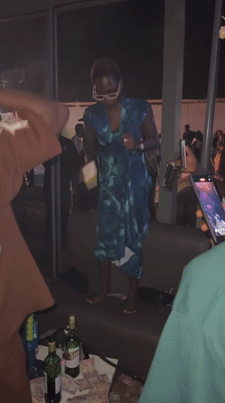 Nighttime party with dancing and poolside activities in Awka