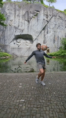 Man performs soccer tricks near Lion Monument in Lucerne