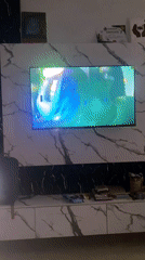 Music video plays on wall-mounted TV in Karmajiji