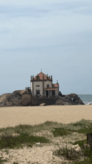 Visitor documents scenic chapel and coastline in Vila Nova de Gaia
