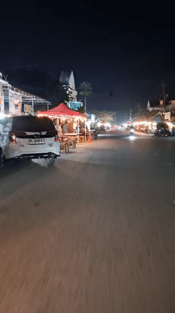 Nighttime street documentation captures evening business activity in Lhokseumawe