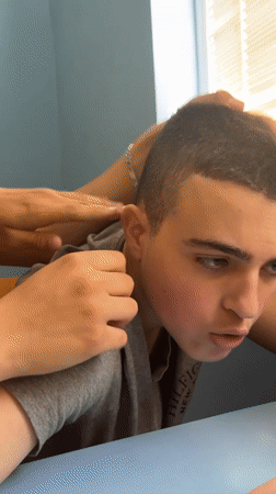 Young men socialize, use phones in Yambol classroom setting