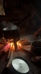 Morning cooking scene captured over wood fire in Oboama