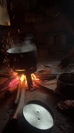 Morning cooking scene captured over wood fire in Oboama