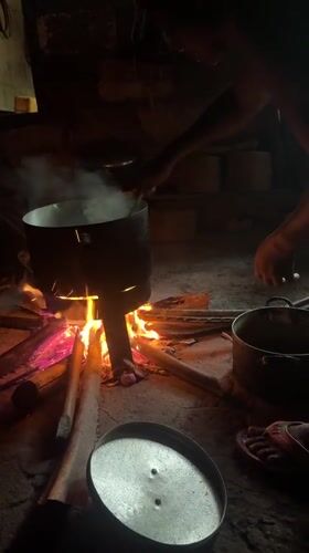 Morning cooking scene captured over wood fire in Oboama