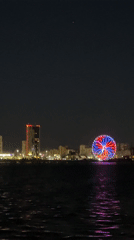 Kazan waterfront illuminated with colorful Ferris wheel, ice cream truck