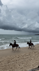 Beach visitors enjoy morning activities under cloudy skies
