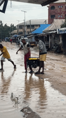 Flooding forces residents to wade through muddy streets in Nigeria