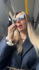 Woman applies lipstick during train journey in Latvia