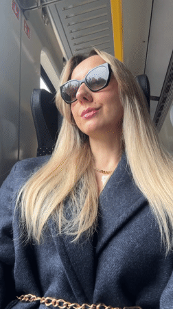 Woman applies lipstick during train journey in Latvia