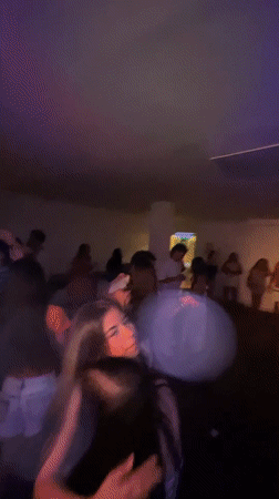 Late-night club dancing under colored lights in Porlamar