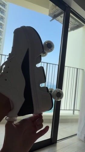 Person displays roller shoe by sunny window in Nha Trang