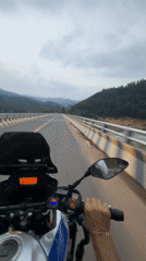 Motorcyclist crosses bridge in Đà Nẵng on overcast morning