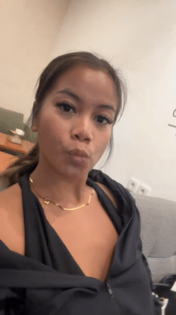 Woman films selfie video indoors in Denpasar