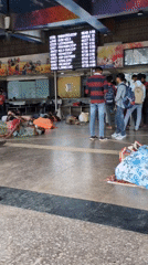 Delhi train station at night, travelers sleeping on the floor