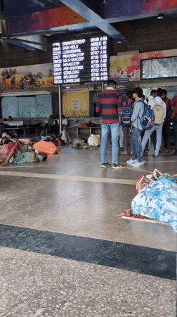 Delhi train station at night, travelers sleeping on the floor