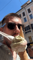 Man enjoys ice cream on sunny afternoon in Milan