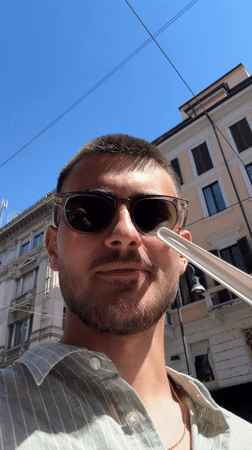 Man enjoys ice cream on sunny afternoon in Milan
