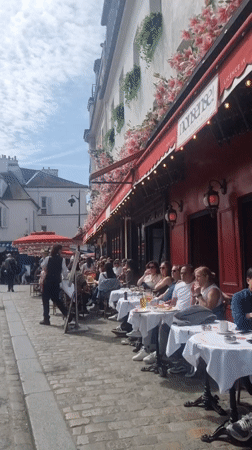 Witness documents typical Parisian street life in Montmartre