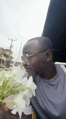 Man with flowers observed in vehicle in Ado, Nigeria