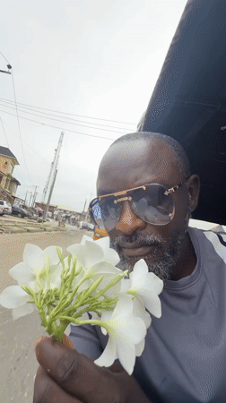 Man with flowers observed in vehicle in Ado, Nigeria