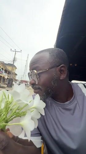 Man with flowers observed in vehicle in Ado, Nigeria