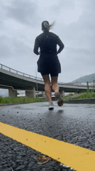 Morning runner exercises on wet Sochi streets amid overcast weather