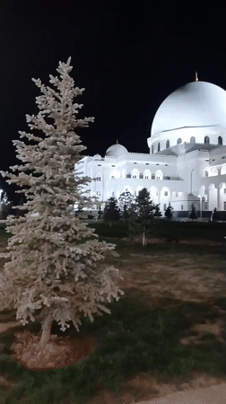 Hazrat Sultan Mosque lit up on a summer night in Shymkent