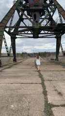 Women visit abandoned industrial crane site for filming