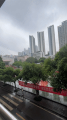 Rainy night street scene observed from balcony in Yuzhong District