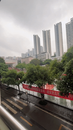 Rainy night street scene observed from balcony in Yuzhong District