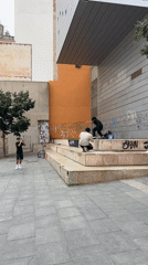 Skateboarder practices tricks on Barcelona streets, record store activity observed
