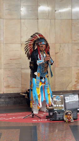 Native American regalia and flute playing on a Moscow street