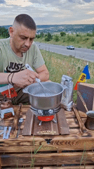 Hand-roasting coffee beans outdoors on a Moldovan hillside