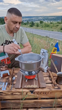 Hand-roasting coffee beans outdoors on a Moldovan hillside