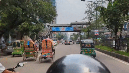 Motorcycle rider documents morning rush hour traffic in Dhaka