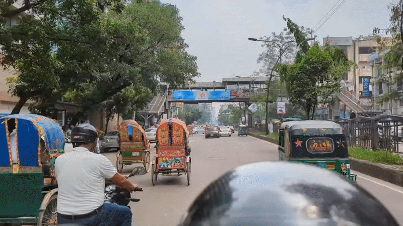 Motorcycle rider documents morning rush hour traffic in Dhaka