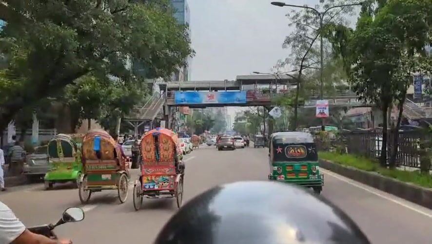 Motorcycle rider documents morning rush hour traffic in Dhaka