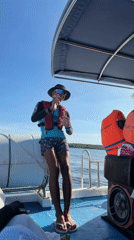 Two young men pose on boat in Indonesian waters