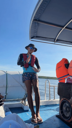 Two young men pose on boat in Indonesian waters