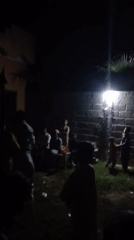 Nighttime gathering captured in Pakistani village courtyard