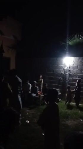 Nighttime gathering captured in Pakistani village courtyard