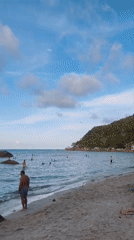 Tourists enjoy beach day, ice cream at Thai resort