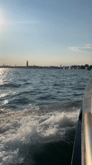 Cutting through choppy water on a sunny day in Venice