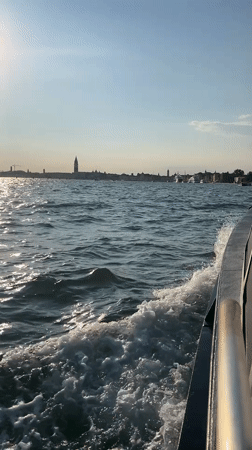 Cutting through choppy water on a sunny day in Venice