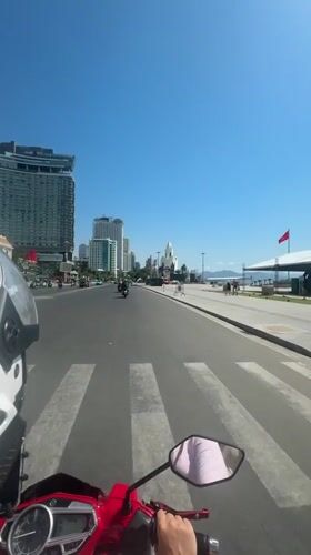 Motorcycle ride through Nha Trang city streets early morning