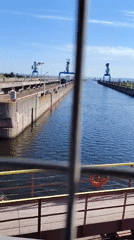 Early morning ship transit documented at Chaikovsky industrial canal