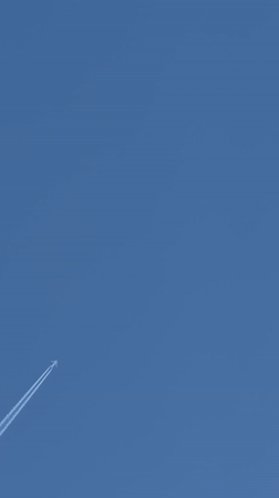 Aircraft contrails spotted over London neighborhood skies