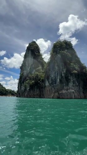 Narrow boat crossing turquoise waters off Khao Phang, Thailand